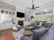 Spacious living room with fireplace, built-in shelving, large windows, and comfortable seating area at 6824 Wood Forest Dr, Cary, NC 27519