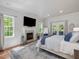 Spacious main bedroom suite with a fireplace, TV, and access to an outdoor deck at 6824 Wood Forest Dr, Cary, NC 27519