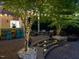 Outdoor bar area with stools, tropical decor, and ambient lighting, ideal for entertaining guests at 6824 Wood Forest Dr, Cary, NC 27519
