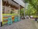 Outdoor bar with a thatched roof and brightly colored stools, ideal for entertaining guests at 6824 Wood Forest Dr, Cary, NC 27519