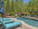 Backyard with a custom pool, waterslide, and lush greenery, creating a private oasis at 6824 Wood Forest Dr, Cary, NC 27519