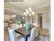 Inviting dining area with modern chandelier, seating for six, and plank flooring at 75 Cordoba Dr, Franklinton, NC 27525