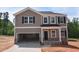 Two-story home featuring stone accents, a two-car garage, and a neutral color scheme at 75 Cordoba Dr, Franklinton, NC 27525