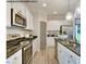 Model kitchen featuring stainless steel appliances, white cabinetry, and granite countertops at 75 Cordoba Dr, Franklinton, NC 27525