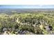 An aerial view showcases the neighborhood and its surrounding lush green trees at 7633 Summer Pines Way, Wake Forest, NC 27587