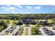 Stunning aerial view of the clubhouse with lush landscaping, trees and parking at 7633 Summer Pines Way, Wake Forest, NC 27587