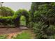 Backyard gate surrounded by lush greenery creating a private entrance at 7633 Summer Pines Way, Wake Forest, NC 27587