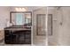 Bathroom featuring a walk-in shower with glass enclosure and dark vanity with granite countertop at 7633 Summer Pines Way, Wake Forest, NC 27587