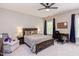Bedroom with a full bed, comfortable armchair, carpet flooring, fan and natural light from a large window at 7633 Summer Pines Way, Wake Forest, NC 27587