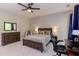 Bedroom featuring a full bed, carpet flooring, fan and natural light from a large window at 7633 Summer Pines Way, Wake Forest, NC 27587