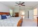 Primary bedroom with hardwood furniture and view of bathroom at 7633 Summer Pines Way, Wake Forest, NC 27587