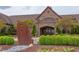 The luxurious stone clubhouse features meticulous landscaping and a welcoming entrance at 7633 Summer Pines Way, Wake Forest, NC 27587