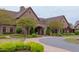 Beautiful stone clubhouse with landscaped entrance and covered entryway for arrivals at 7633 Summer Pines Way, Wake Forest, NC 27587