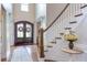 Elegant foyer with hardwood floors, staircase, and decorative glass doors, offering a warm welcome at 7633 Summer Pines Way, Wake Forest, NC 27587