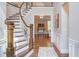 Inviting foyer with a curved staircase and open layout, showcasing hardwood floors and neutral decor at 7633 Summer Pines Way, Wake Forest, NC 27587