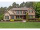 Charming stone and shingle two-story home with manicured landscaping and a welcoming front porch at 7633 Summer Pines Way, Wake Forest, NC 27587
