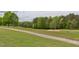 Expansive golf course view featuring lush greens, manicured fairways, and mature trees at 7633 Summer Pines Way, Wake Forest, NC 27587