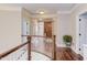 Hallway featuring hardwood floors and a decorative barn door at 7633 Summer Pines Way, Wake Forest, NC 27587
