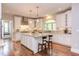 Large open-concept kitchen features white cabinetry, granite countertops, an island, and modern lighting at 7633 Summer Pines Way, Wake Forest, NC 27587