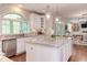 Modern kitchen with granite countertops, stainless steel appliances, and white cabinets at 7633 Summer Pines Way, Wake Forest, NC 27587