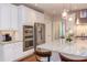 Bright kitchen featuring white cabinets, granite counters, stainless appliances, and eat-in island at 7633 Summer Pines Way, Wake Forest, NC 27587