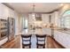 Spacious kitchen with white cabinets, granite countertops, stainless appliances, and seating at island at 7633 Summer Pines Way, Wake Forest, NC 27587