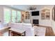 Bright living room with a fireplace, built-ins, large windows, and comfortable seating at 7633 Summer Pines Way, Wake Forest, NC 27587