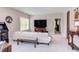 Bright living room with a white couch and a view into another room through the doorway at 7633 Summer Pines Way, Wake Forest, NC 27587