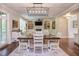 Open-concept dining and living room featuring hardwood floors and natural light at 7633 Summer Pines Way, Wake Forest, NC 27587