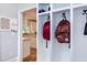 Mudroom area featuring cubbies and hooks, open to a brightly lit kitchen at 7633 Summer Pines Way, Wake Forest, NC 27587