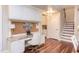 Home office area featuring custom built-in desk, cabinets, granite countertop and hardwood floors at 7633 Summer Pines Way, Wake Forest, NC 27587