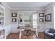 Bright office featuring a desk with bay window, hardwood floors, and custom wall trim at 7633 Summer Pines Way, Wake Forest, NC 27587