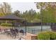 Outdoor seating area next to tennis court for socializing and viewing games at 7633 Summer Pines Way, Wake Forest, NC 27587