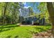 Spacious backyard boasts a lush lawn and mature trees, offering a serene outdoor retreat at 7653 Summerglen Dr, Raleigh, NC 27615