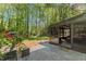 Landscaped backyard with an enclosed patio and lush greenery at 7653 Summerglen Dr, Raleigh, NC 27615