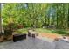 Backyard patio with seating and a lush lawn at 7653 Summerglen Dr, Raleigh, NC 27615
