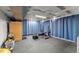 Unfinished basement with rubber flooring, blue privacy curtains, and exercise equipment at 7653 Summerglen Dr, Raleigh, NC 27615