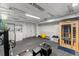 Unfinished basement with rubber flooring, laundry area, sauna, and exercise equipment at 7653 Summerglen Dr, Raleigh, NC 27615