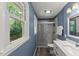 Modern bathroom with a glass-enclosed shower and large window for natural light at 7653 Summerglen Dr, Raleigh, NC 27615