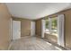 Bedroom featuring a window with curtains, neutral carpet, and closet at 7653 Summerglen Dr, Raleigh, NC 27615