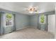 Bedroom featuring two windows, neutral carpet, ceiling fan, and neutral colored walls at 7653 Summerglen Dr, Raleigh, NC 27615