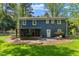 Rear exterior of the home with a patio and a spacious backyard at 7653 Summerglen Dr, Raleigh, NC 27615
