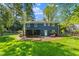 Back of the house with large backyard and enclosed patio at 7653 Summerglen Dr, Raleigh, NC 27615