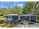 Charming blue home with a quaint front porch and lush green landscaping at 7653 Summerglen Dr, Raleigh, NC 27615