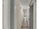 Hallway with wood flooring and doors leading to various rooms at 7653 Summerglen Dr, Raleigh, NC 27615