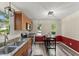 Bright kitchen with stainless appliances, wood cabinets, and a cozy breakfast nook at 7653 Summerglen Dr, Raleigh, NC 27615