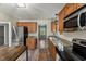 Spacious kitchen with stainless steel appliances, granite countertops, and wood flooring at 7653 Summerglen Dr, Raleigh, NC 27615