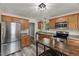 Modern kitchen featuring stainless steel appliances, wooden cabinets and granite countertops at 7653 Summerglen Dr, Raleigh, NC 27615