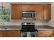 Bright kitchen featuring granite countertops, stainless steel appliances, and ample cabinet space at 7653 Summerglen Dr, Raleigh, NC 27615