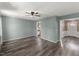 Large open living room with bright neutral paint, wood floors and lots of light at 7653 Summerglen Dr, Raleigh, NC 27615